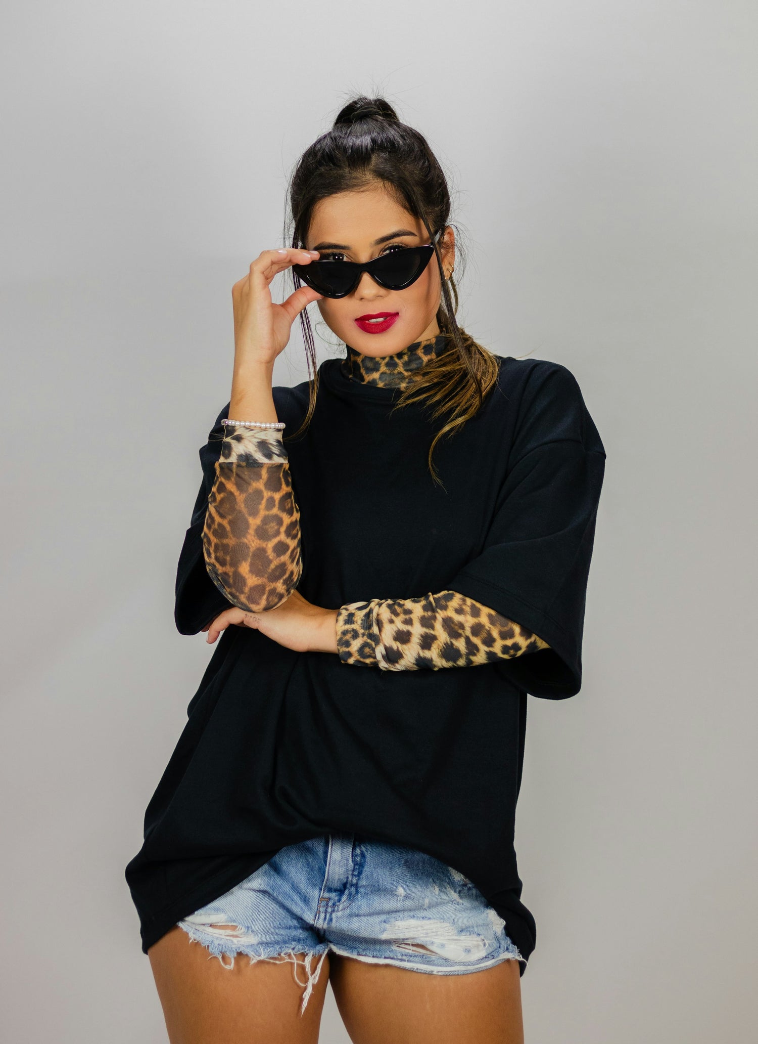 Woman wearing a bold leopard print shirt